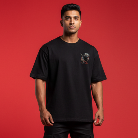 Man wearing a black t-shirt with a small graphic on a red background