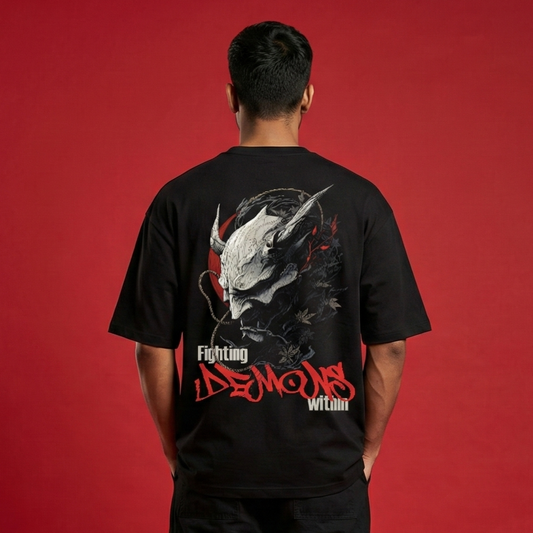 Person wearing a black t-shirt with a graphic design on the back against a red background