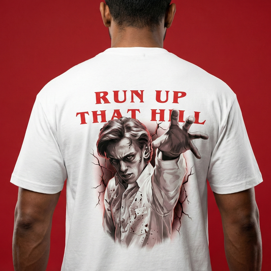Person wearing a white t-shirt with a graphic design and text on the back against a red background, Run Up That Hill t-shirt, running up that hill tshirt, stranger things tshirt