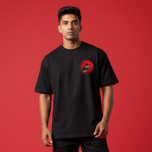 Man wearing a black t-shirt with a red graphic on a red background
